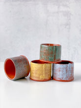 Load image into Gallery viewer, Set of four ceramic pots with textured surfaces on a light background